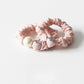 Strawberry hair tie displayed on a white background showing the elastic band