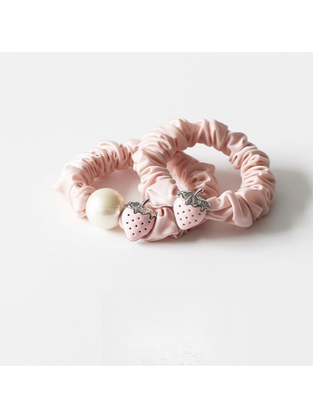 Strawberry hair tie displayed on a white background showing the elastic band