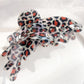 Beau butterfly shaped claw clip with leopard print on neutral background