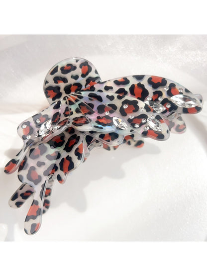 Beau butterfly shaped claw clip with leopard print on neutral background