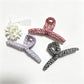 Close-up of Beau plaid fabric wrapped claw clip highlighting fabric texture