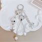 Keypus keychain showing star and bow charms hanging from gold ring