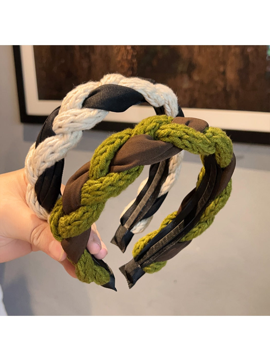 Close-up of vintage knitted twist headband in beige on white background