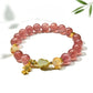 Lovra bracelet featuring goldfish pendant and clear crystal beads on wrist