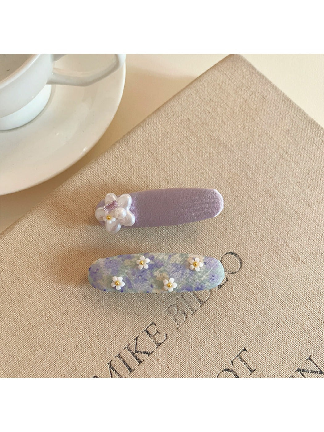 Model wearing Beau purple tiny flower hair clip in styled hair