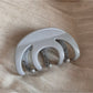 Top view of Beau smooth surface hair clip highlighting its curved shape