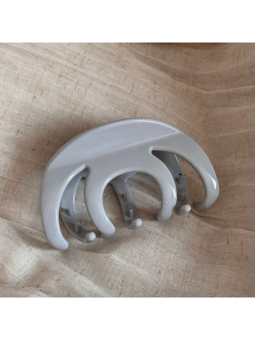 Top view of Beau smooth surface hair clip highlighting its curved shape