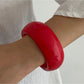Lovra wide round bangle bracelet displayed with focus on smooth, seamless metal finish