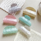 Close-up of Beau crescent shaped claw clip showing pastel macaron colors