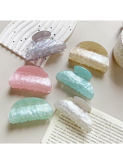 Close-up of Beau crescent shaped claw clip showing pastel macaron colors