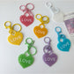Solid color heart-shaped pendant keychain in red on a white background