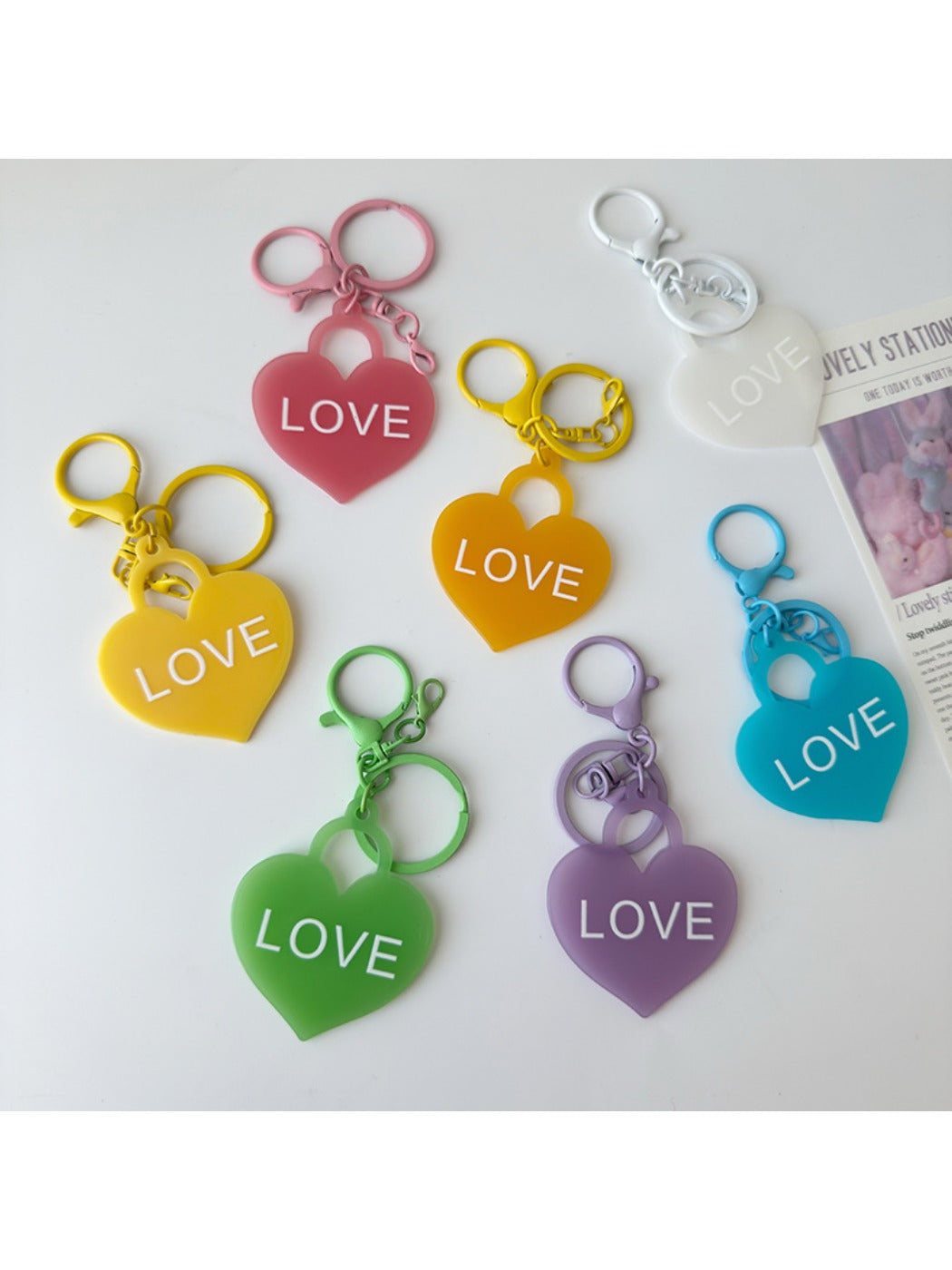 Solid color heart-shaped pendant keychain in red on a white background