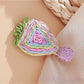 Beau raffia woven strawberry flower hair clip photographed with soft lighting