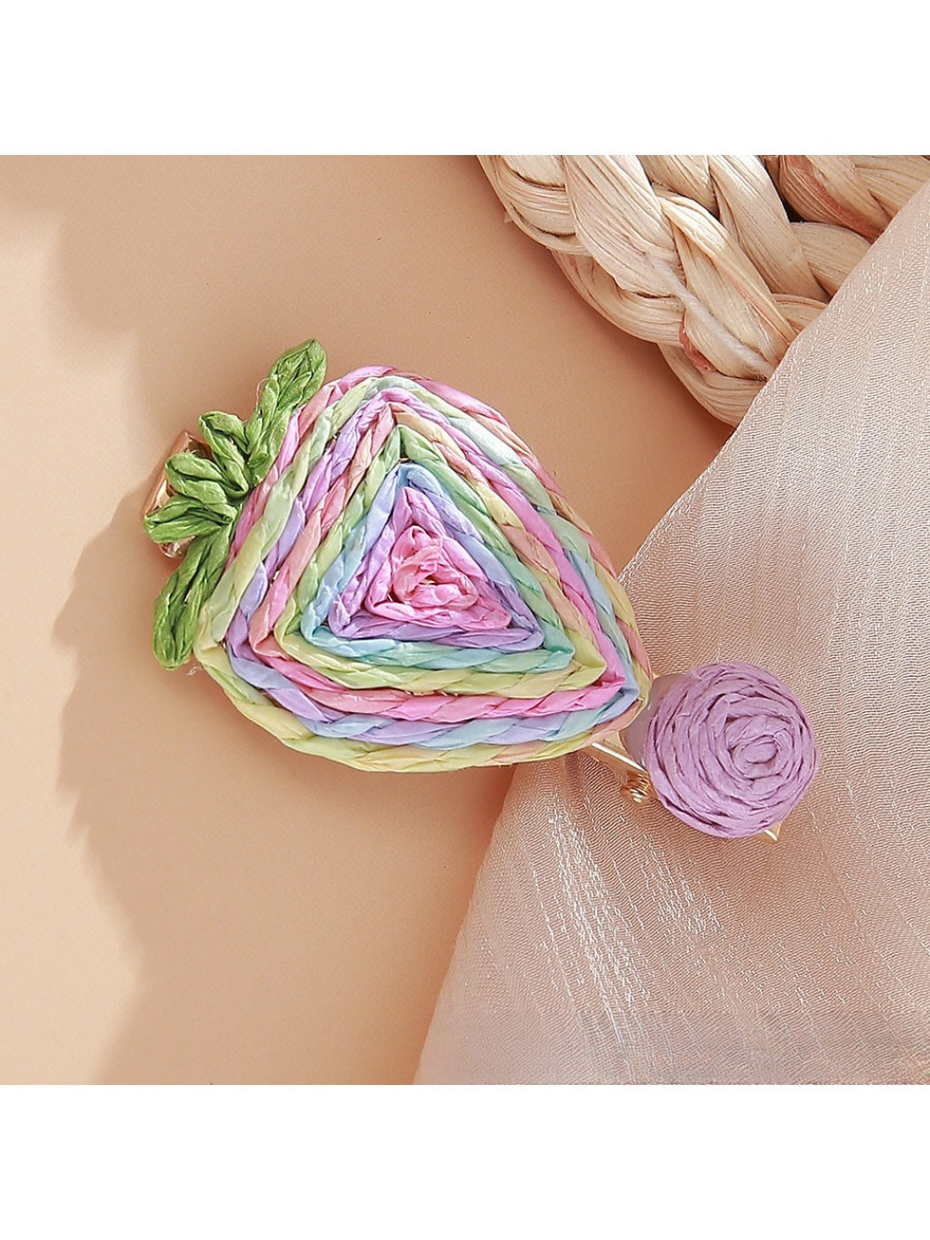 Beau raffia woven strawberry flower hair clip photographed with soft lighting