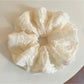 Close-up of a chic solid color ruffled scrunchie on a white background