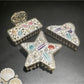 Close-up of Beau beach style artistic hair clip with seashell design on white background