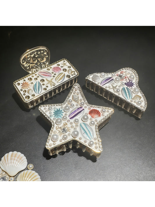 Close-up of Beau beach style artistic hair clip with seashell design on white background
