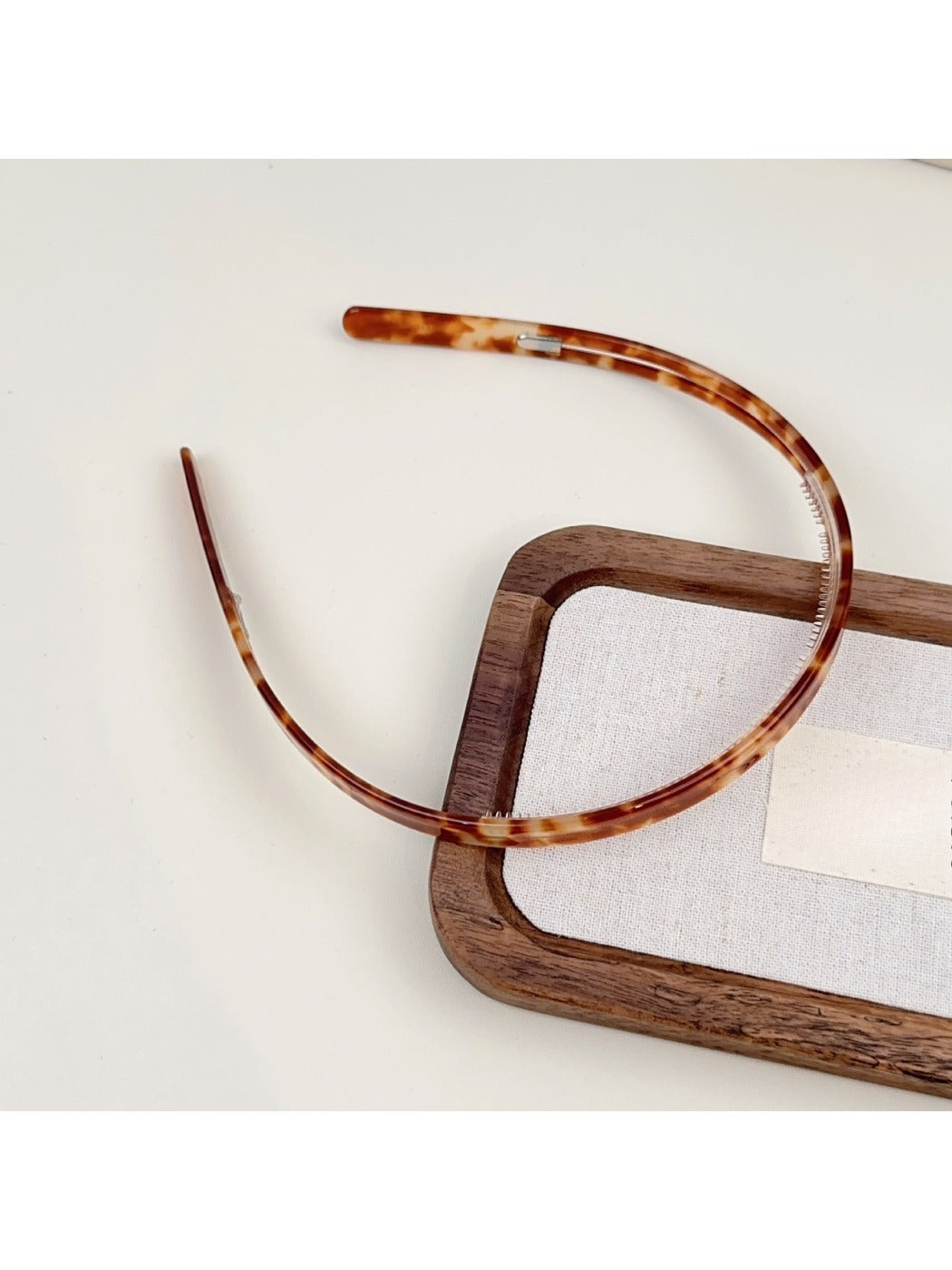 Gifty headband resting on fabric background showcasing solid color