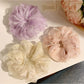Close-up of a solid color ruched scrunchie with minimalist design on a white background
