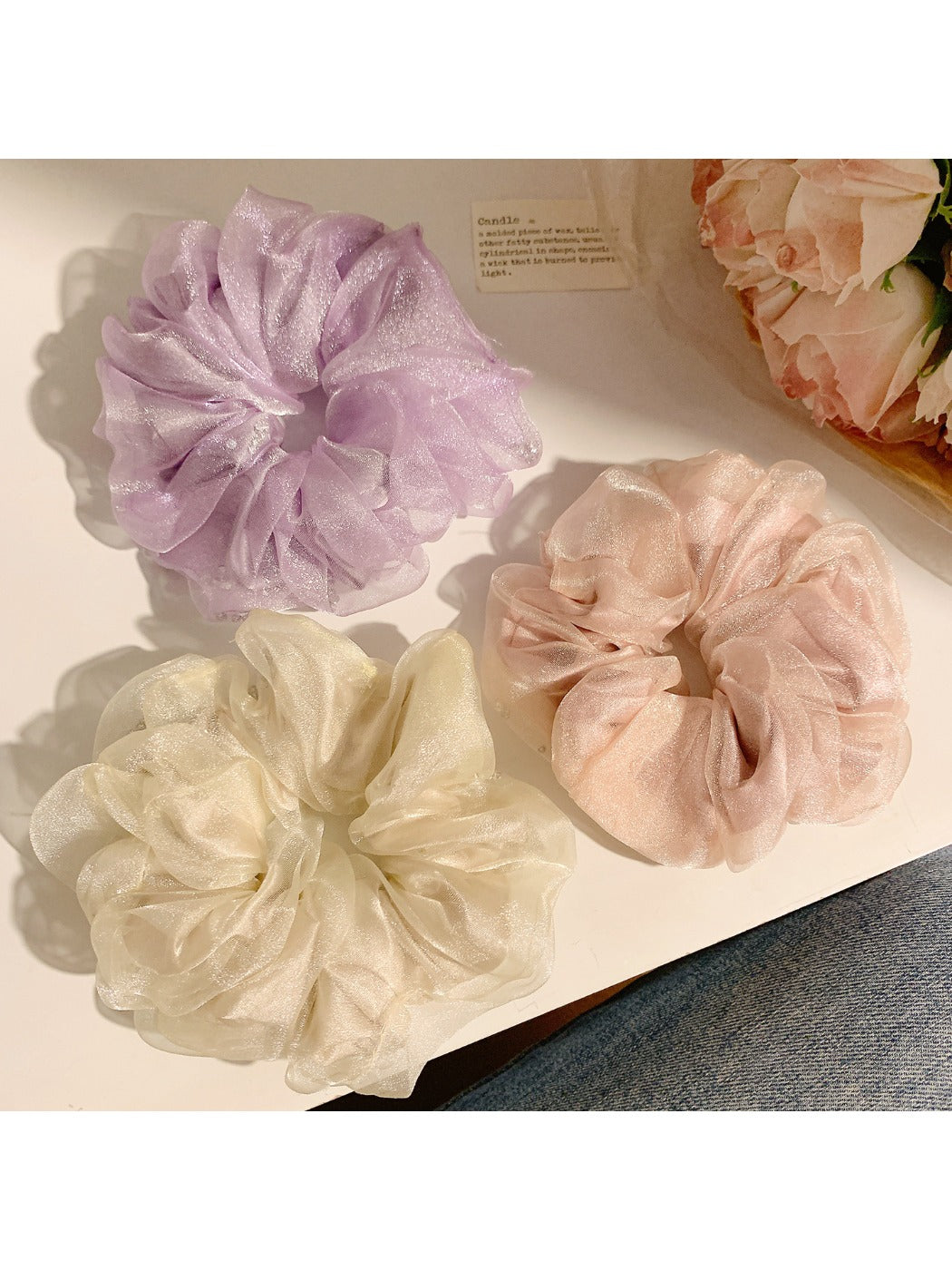 Close-up of a solid color ruched scrunchie with minimalist design on a white background