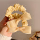 Gifty hair tie with sweet bow detail displayed on a white background