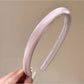 Smooth satin headband folded to highlight soft fabric and bright color