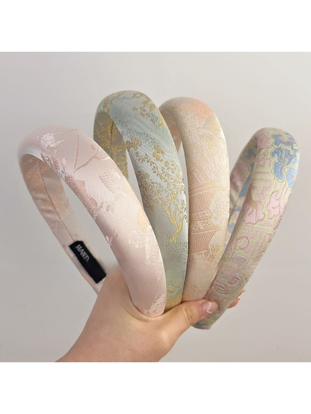 Top view of Gifty fabric headband featuring colorful embroidered flowers