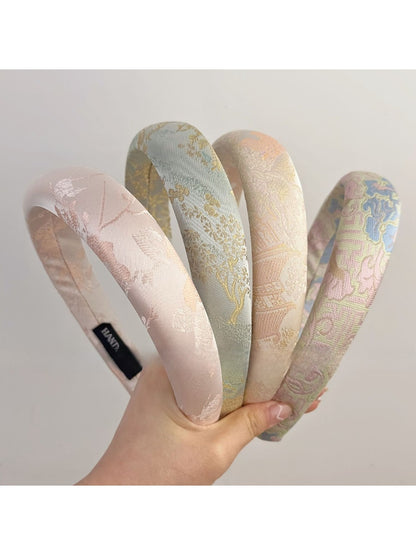 Top view of Gifty fabric headband featuring colorful embroidered flowers