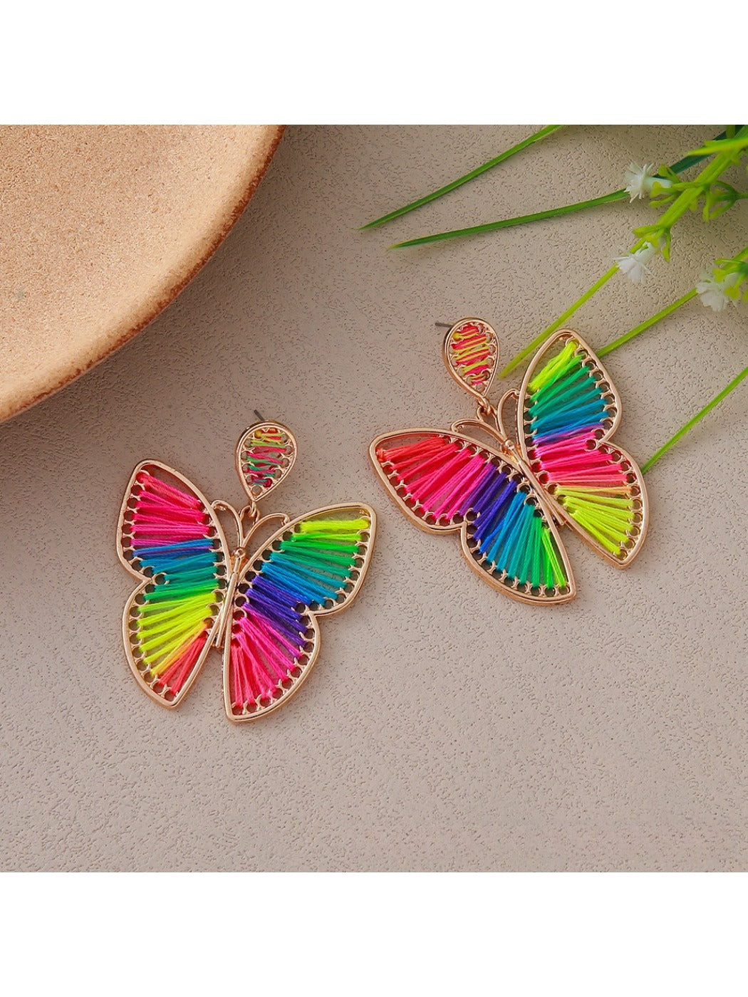 Side view of butterfly shaped drop earrings showing delicate wing details