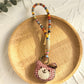 Keypus fabric doll keychain displayed on a wooden surface