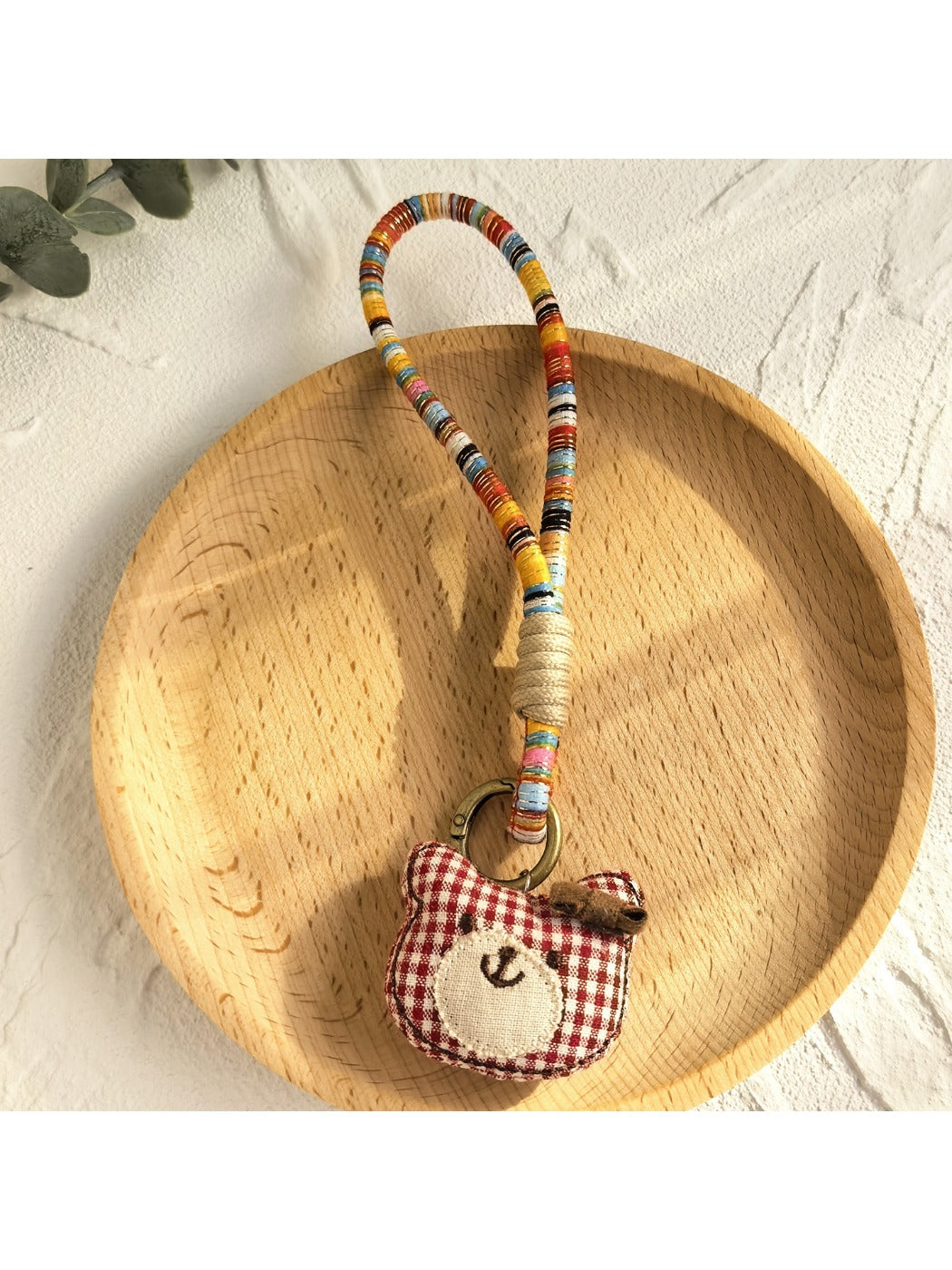 Keypus fabric doll keychain displayed on a wooden surface