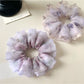 Close-up of Gifty elegant purple scrunchie with floral print on fabric