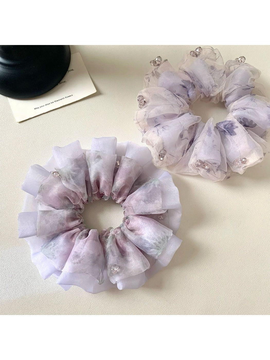 Close-up of Gifty elegant purple scrunchie with floral print on fabric