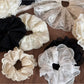 Gifty refined lace scrunchie styled in a woman's hair from side view