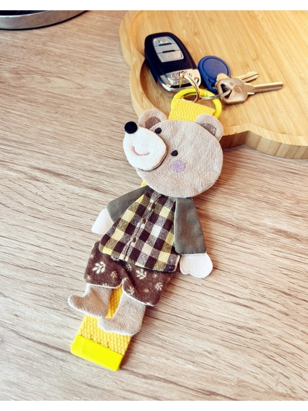 Top view of the bear keychain showing the keyring and fabric details