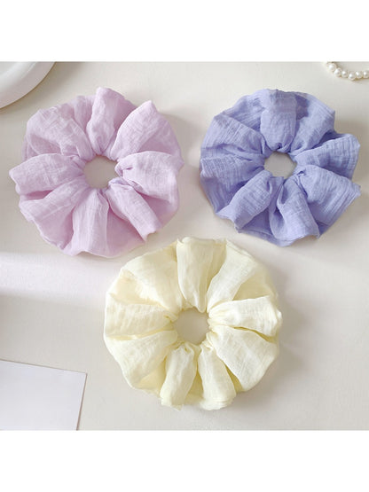 Colorful scrunchie with a soft, gathered fabric design for casual wear