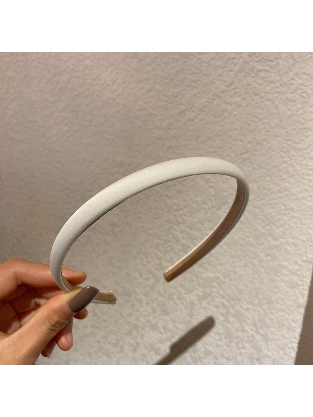 Candy color satin headband displayed flat with soft lighting