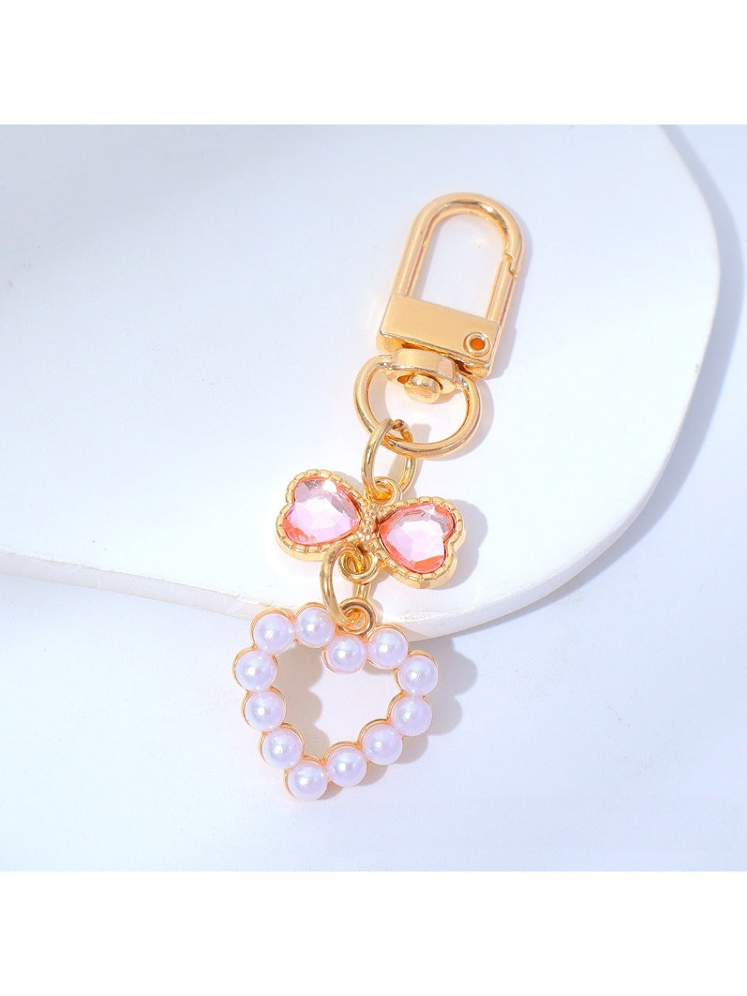 Side angle of a colorful beaded heart keychain with a metal keyring