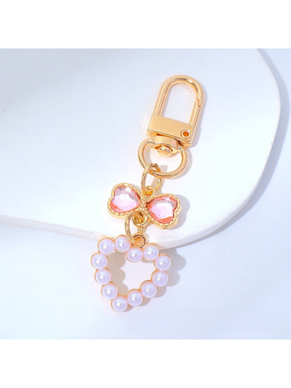 Side angle of a colorful beaded heart keychain with a metal keyring