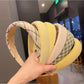 Sweet yellow style headband with a bow detail on a white background