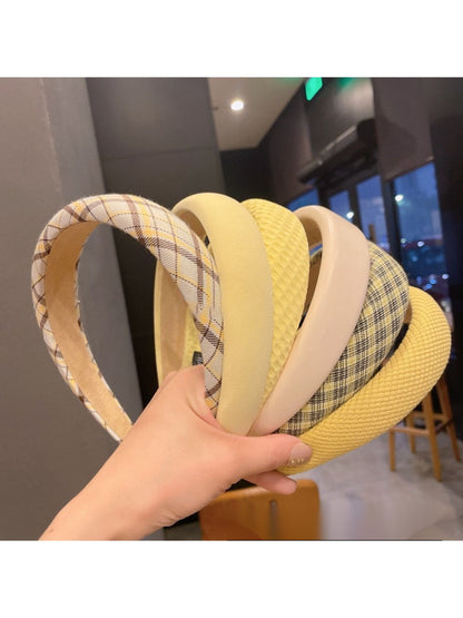 Sweet yellow style headband with a bow detail on a white background