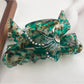 Beau hair claw clip with vibrant butterfly patterns on a neutral background