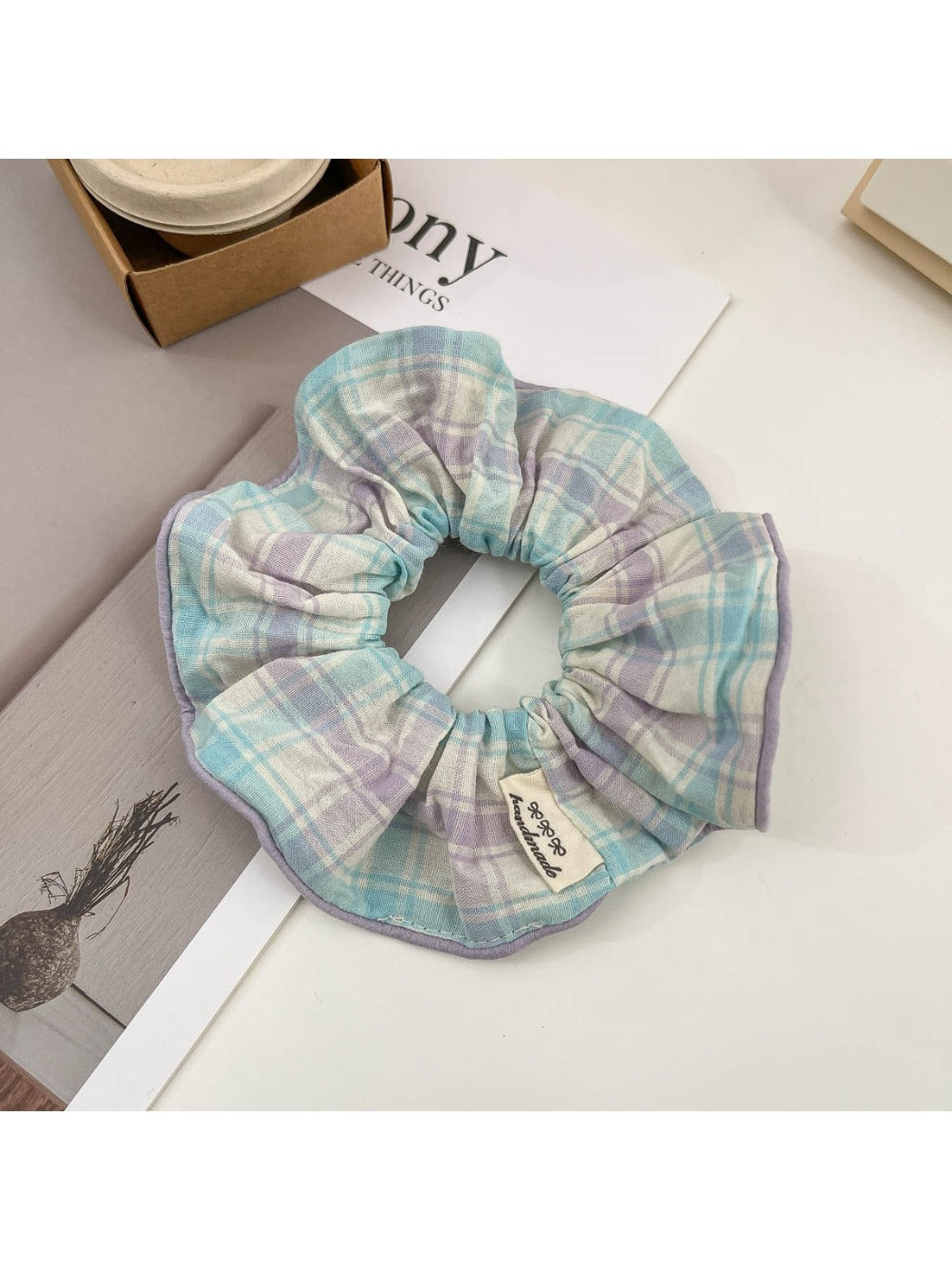 Plaid hair clip clipped into a section of hair on a model