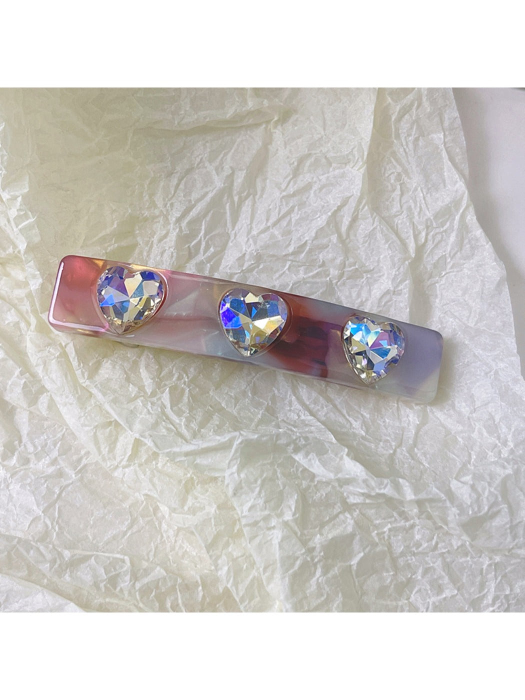 Green square hair clip displayed alongside other colorful clips