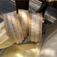 Soft straw woven lace headband in natural beige color displayed on white background