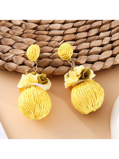 Pair of Earedge fabric flower raffia ball earrings with gold-tone hooks