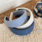Gifty headband displayed flat highlighting diamond pattern and fabric detail