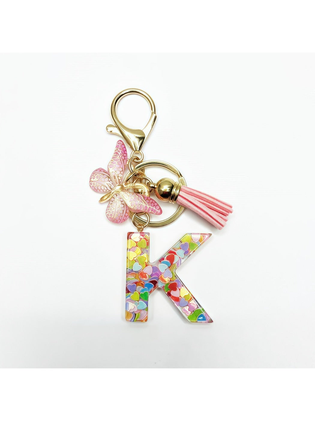 Keychain with butterfly and letter pendant placed on a fabric background