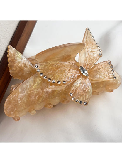 Beau hair claw clip open showing spring mechanism and butterfly design