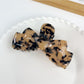 Beau hair claw clip shown with a soft shadow on white background